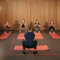 Coach leading a group through bodyweight squats